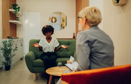A woman is sitting in an office with her psychotherapist talking about issues with her Mental health